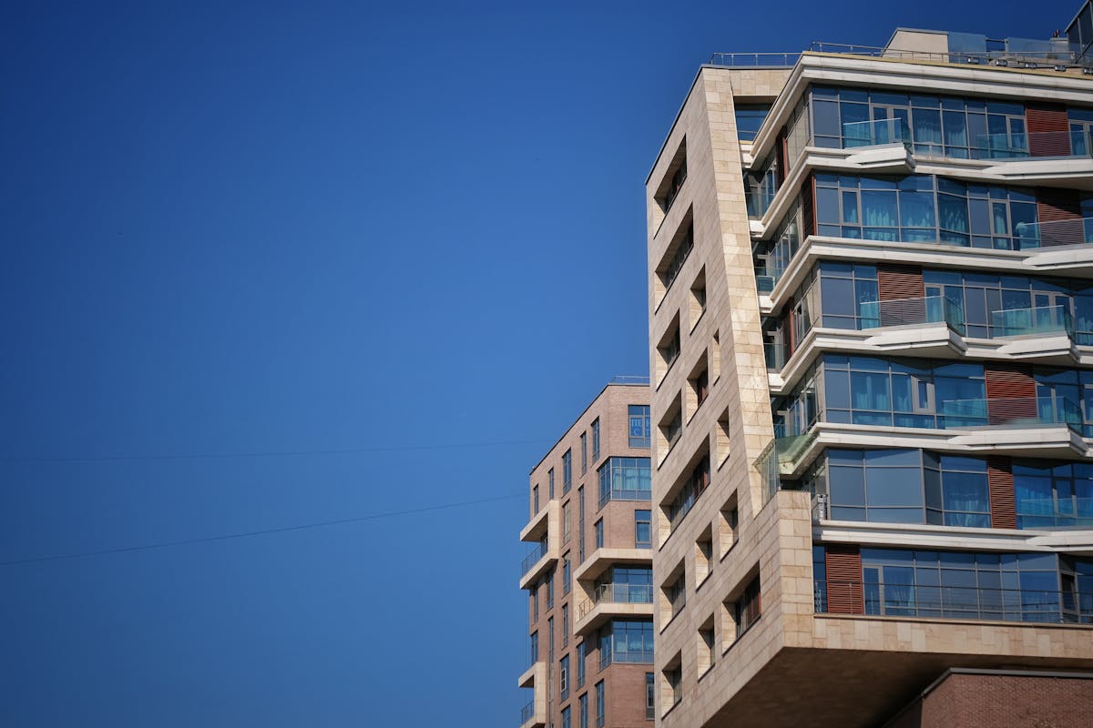 Small glass of bright yellow ginger turmeric shot on a wooden board