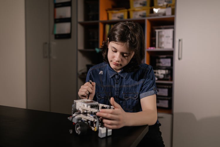 A Boy Holding A Toy Car