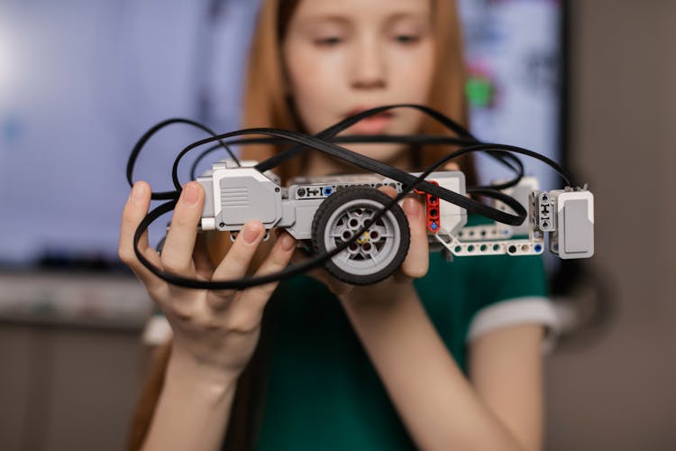 A Girl Holding A Toy Car