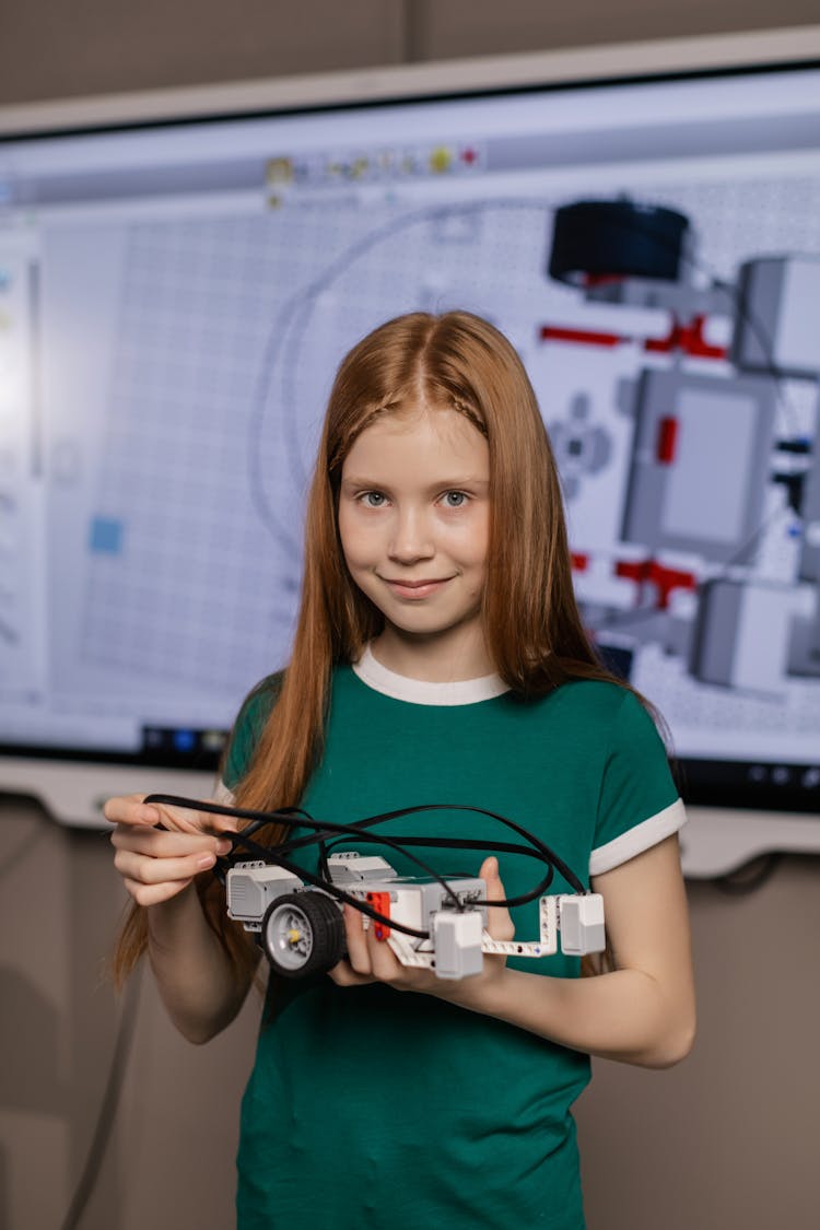 A Girl Holding A Toy Car