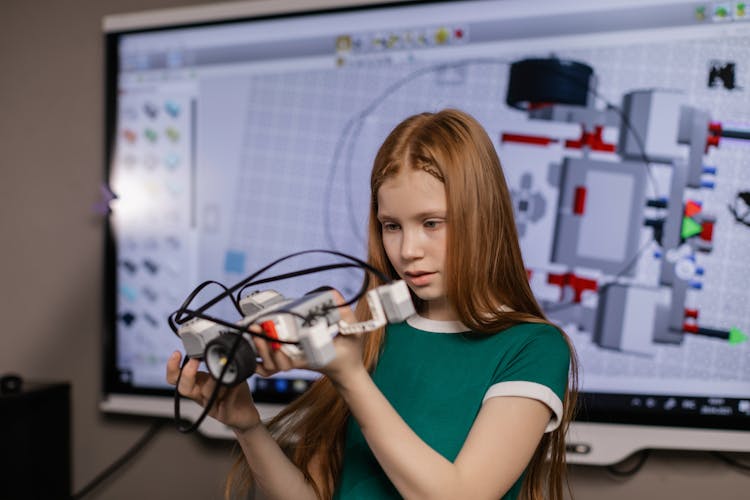 A Girl Holding A Toy Car