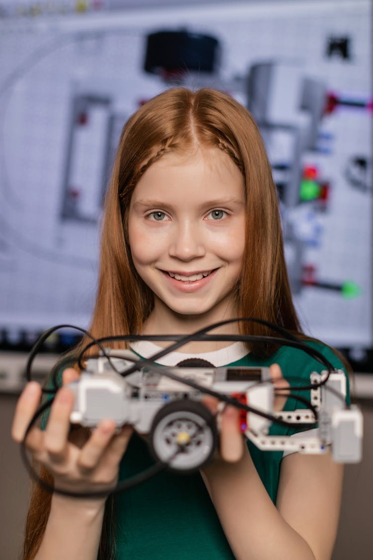 A Girl Holding A Toy Car