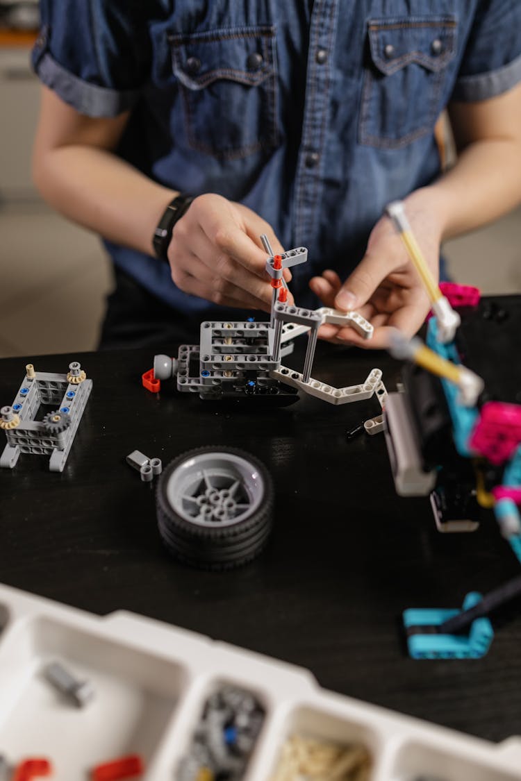 A Person Building A Toy Car