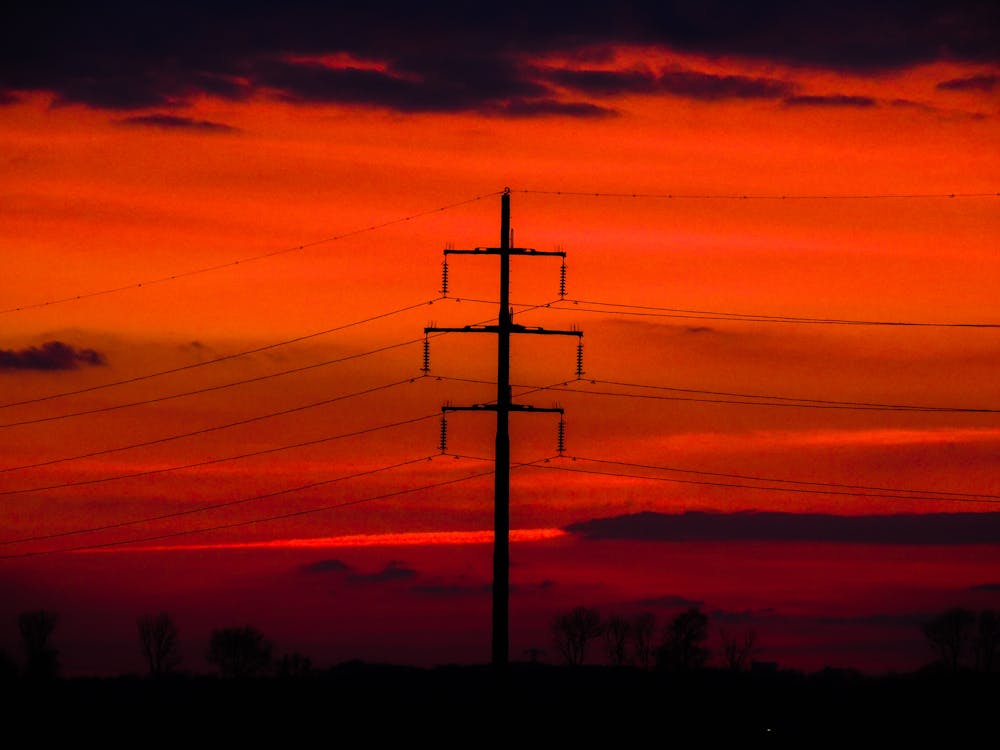 Silhouette of Electric Post during Sunset