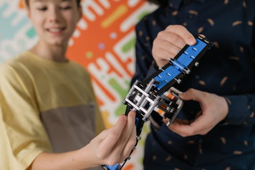 Two Boys Holding a Robotics Device