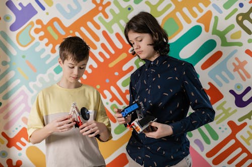 Two Boys Holding Robotic School Projects