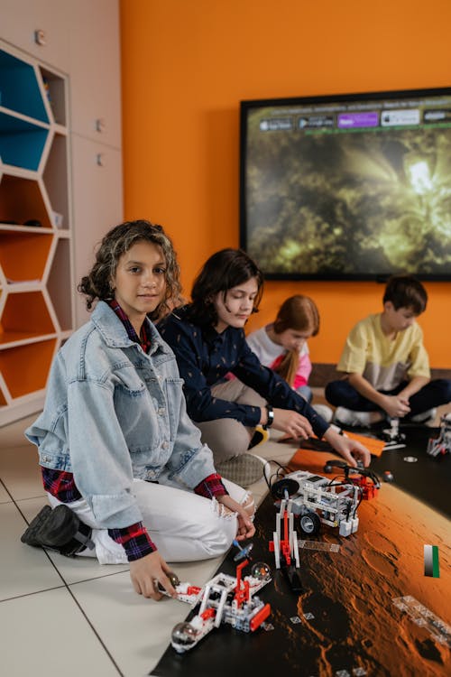 Free Children Sitting on the Floor While Playing  Stock Photo