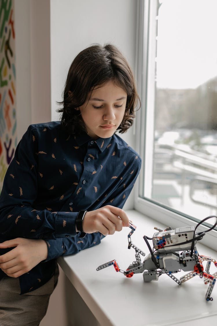 Kid Playing With A Robot