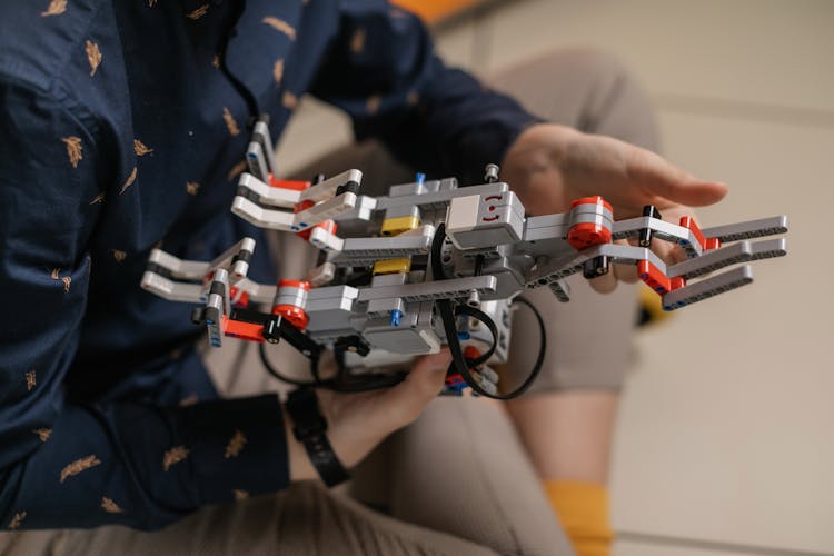 Person Holding A Robotic Toy Blocks