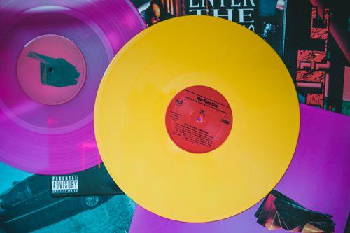 Free Vibrant yellow and pink vinyl records on colorful album covers. Stock Photo