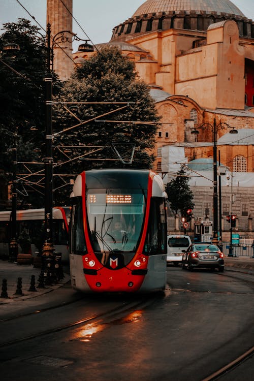 Red and White Tram on Road