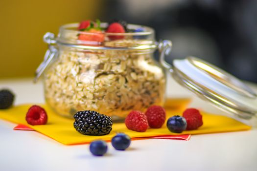 A vibrant and healthy breakfast jar filled with oats and fresh berries, showcasing delicious and nutritious ingredients.
