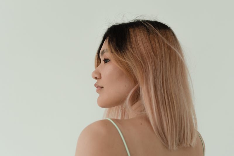 Hand-painted balayage color being applied to hair