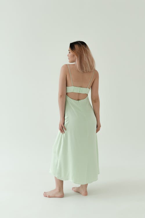 Back View of a Woman in Green Spaghetti Strap Dress