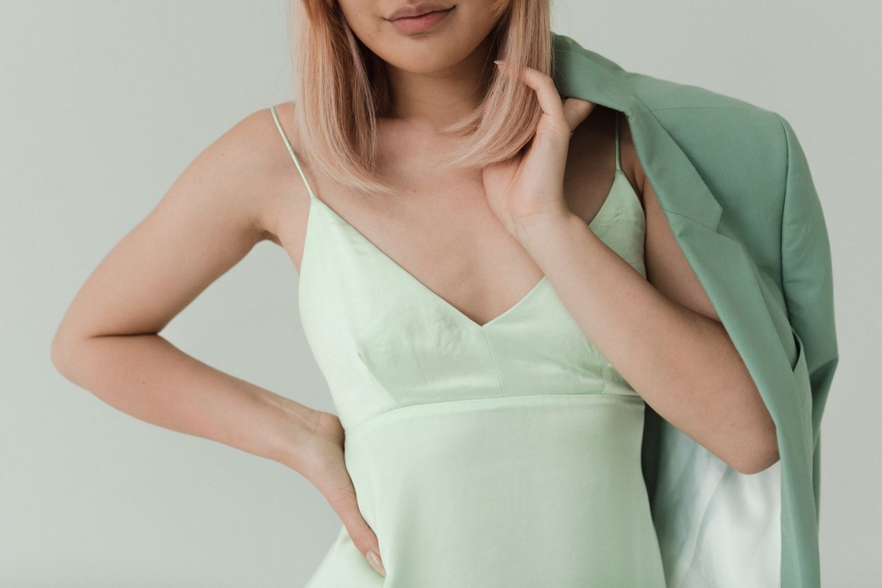 Close-up of a mint green camisole and sage blazer, two classic muted summer shades
