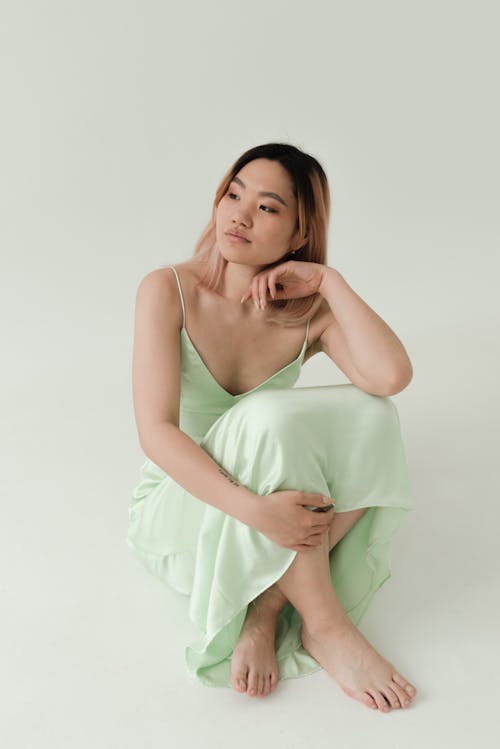 Woman in Green Dress Sitting on the Floor