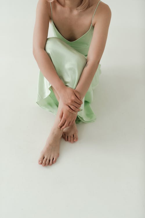 Person in Green Dress Sitting on the Floor