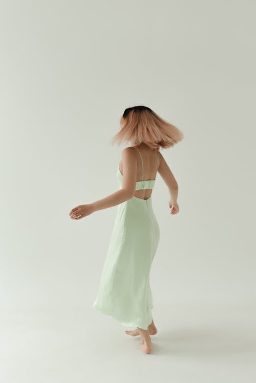 A Woman Wearing a Backless Dress Spinning Around
