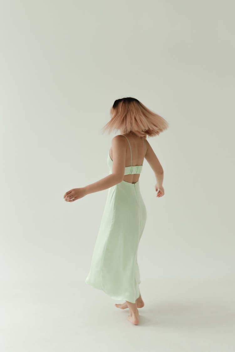 A Woman Wearing A Backless Dress Spinning Around