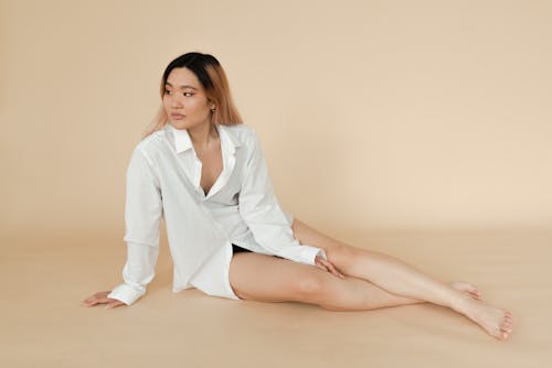 A Woman Wearing a Dress Shirt Sitting on the Floor