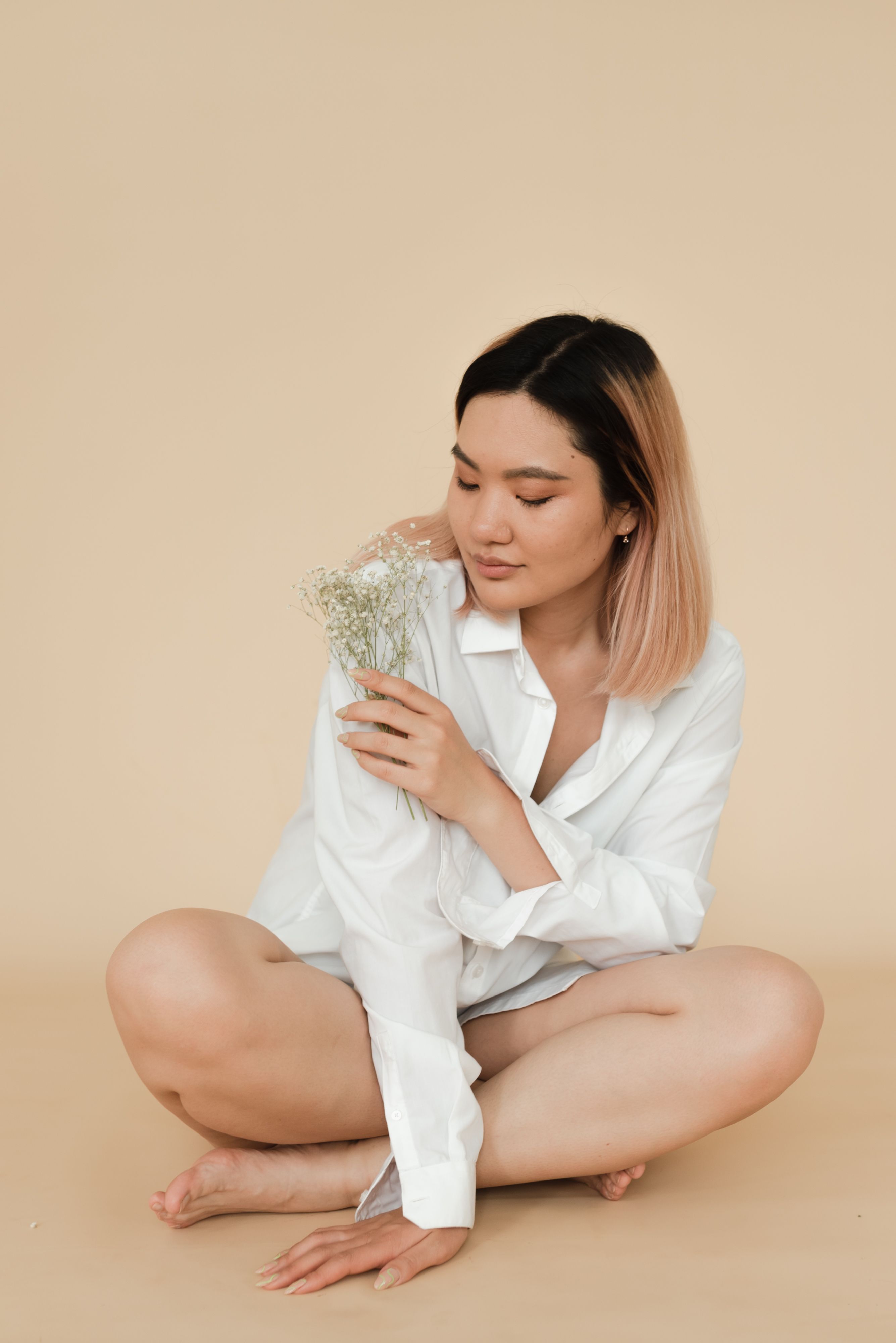 A Woman in a Dress Shirt Posing while Sitting on the Floor · Free Stock ...