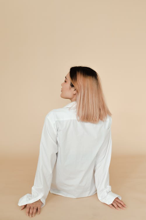 Back View of Woman in White Long Sleeve Shirt