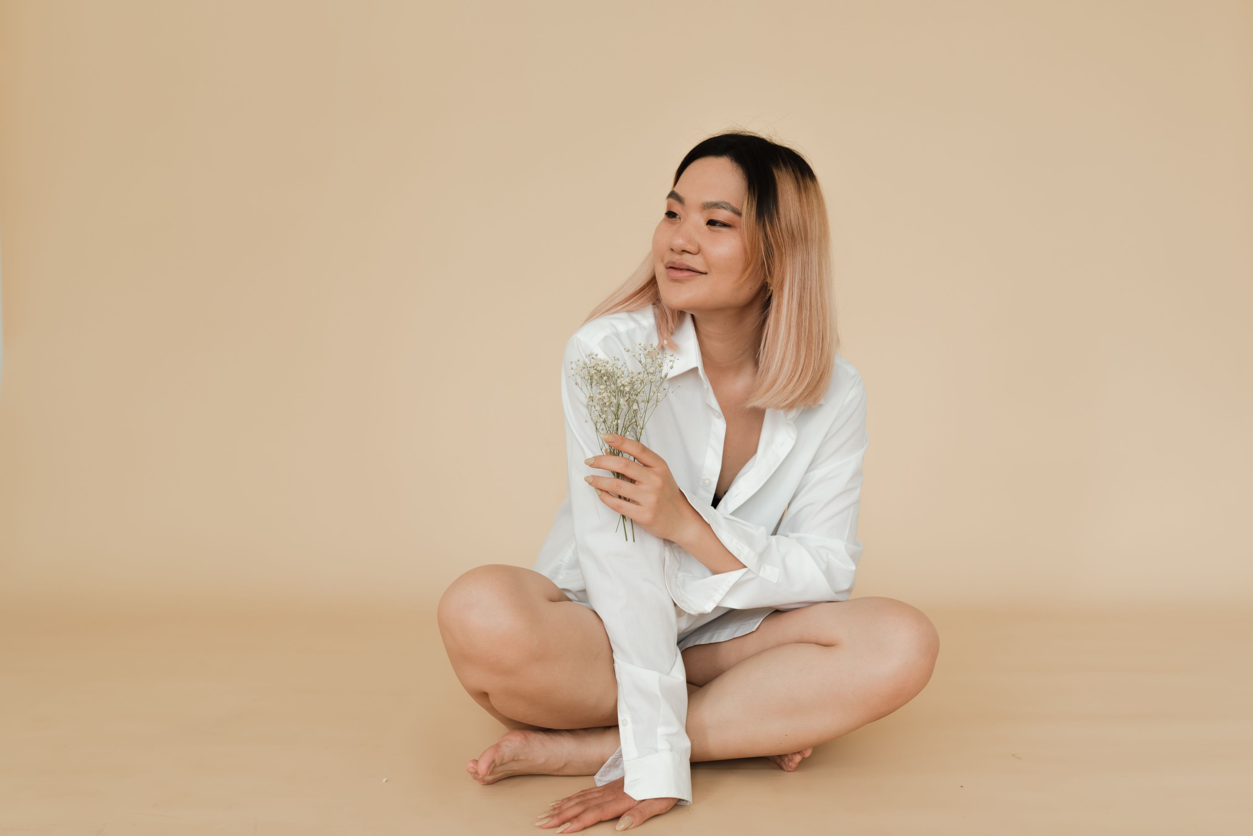 Woman in White Long Sleeves Sitting on the Floor · Free Stock Photo