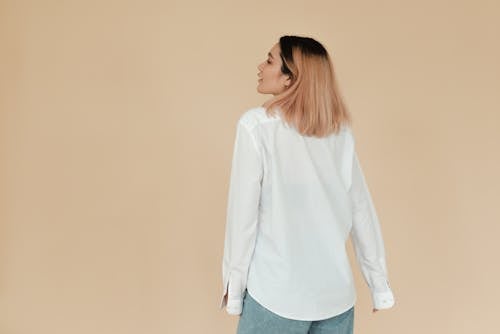 Woman in White Long Sleeves and Denim Jeans