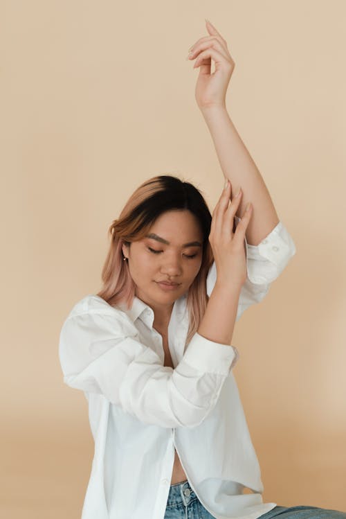 A Woman Legs Apart in Sitting on a Chair · Free Stock Photo