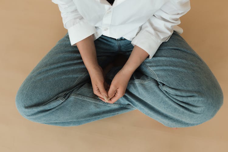 Flatlay Shot Of Person In White Button Up Shirt And Denim Jeans