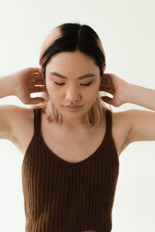 A Woman in Brown Knitted Tank Top Looking Down