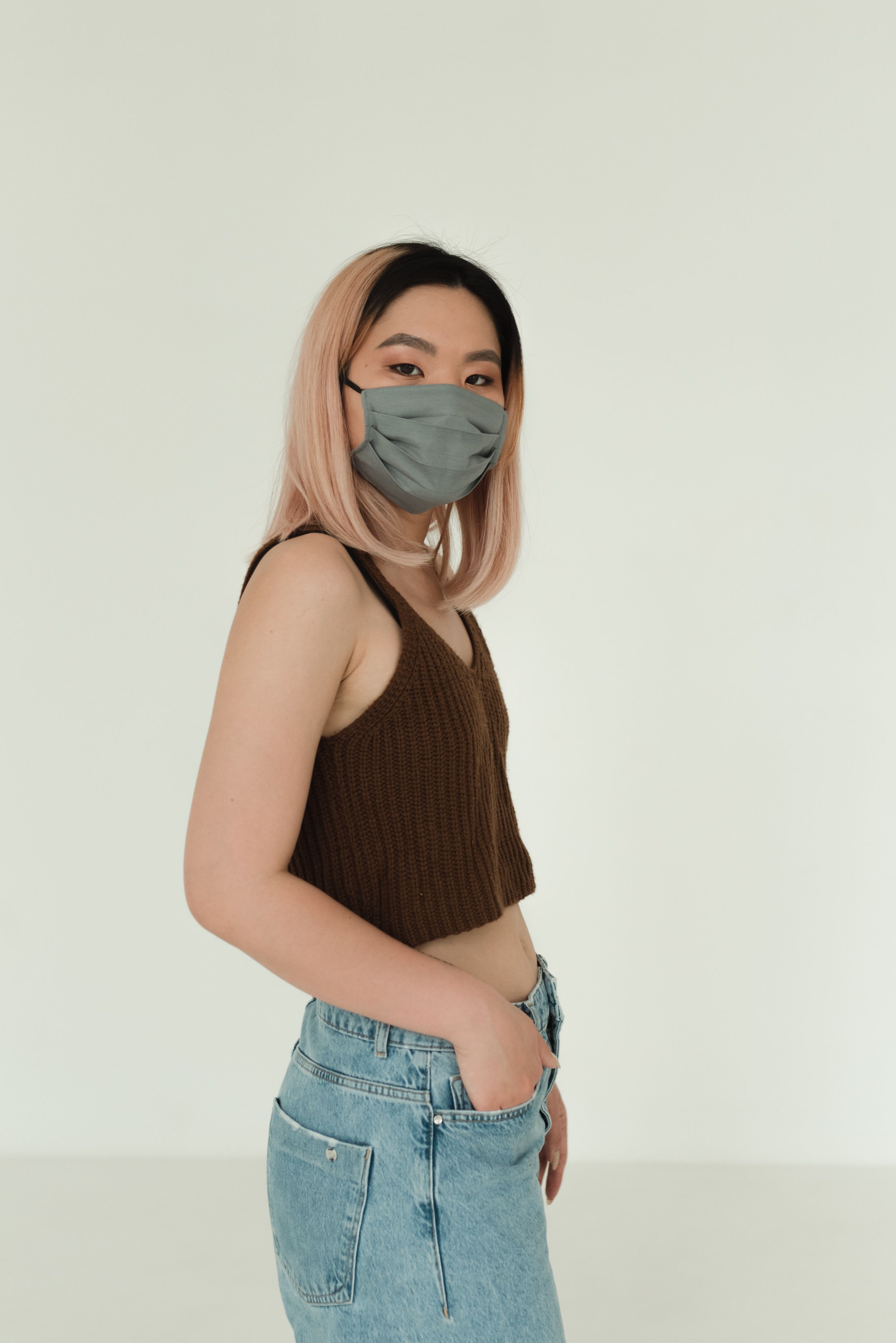 A Woman in Brown Tank Top and Blue Denim Jeans Wearing Face Mask · Free ...