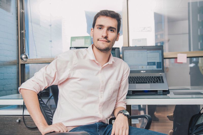 Confident young man in shirt working in modern office