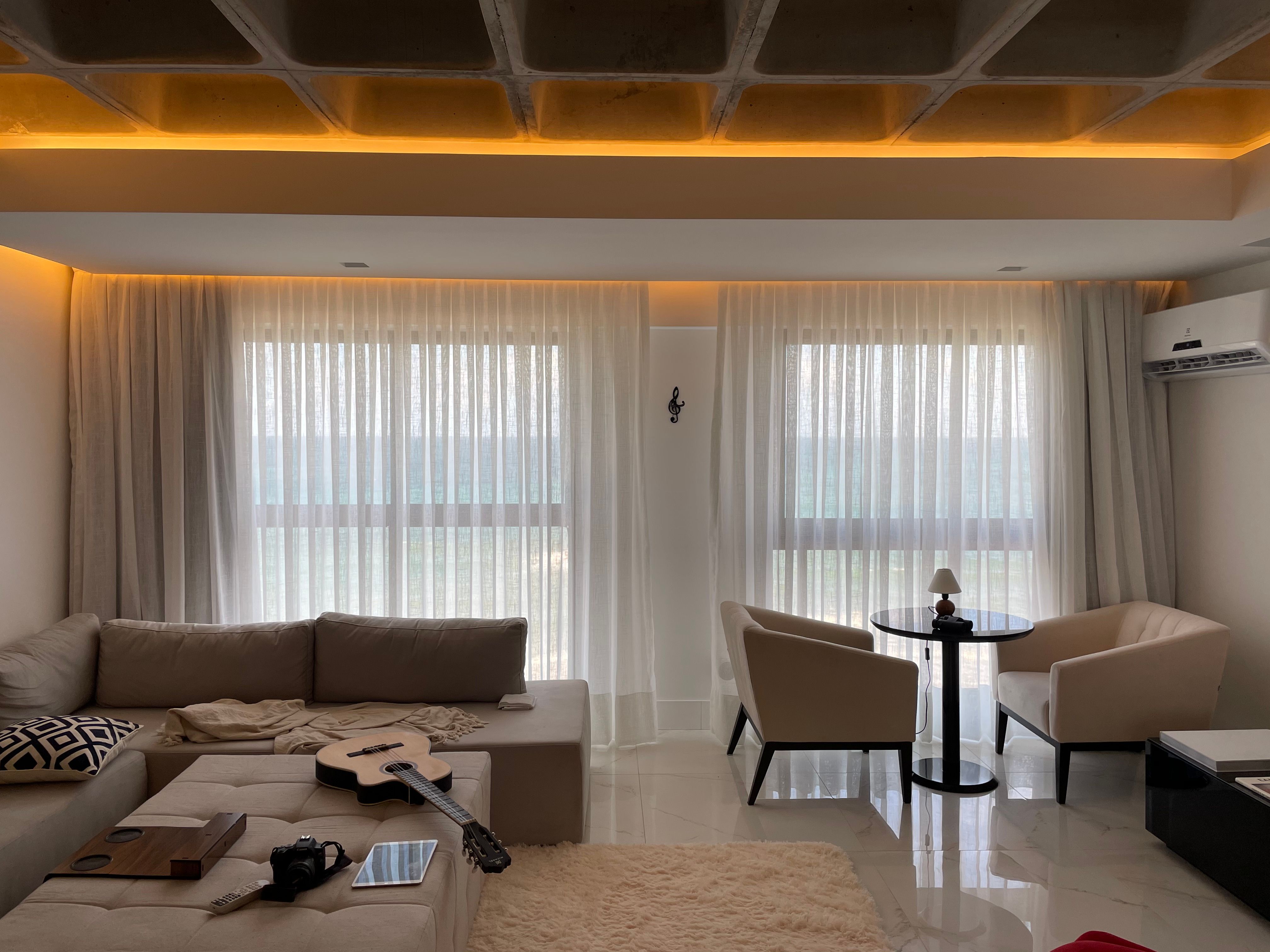 quiet luxury apartment design with amazon finds Contemporary living room with a cozy and elegant design featuring soft lighting, a couch, and a coffee table.