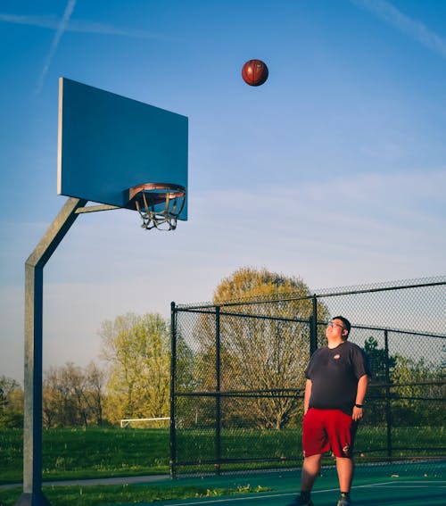 A Man Looking at the Basketball Court