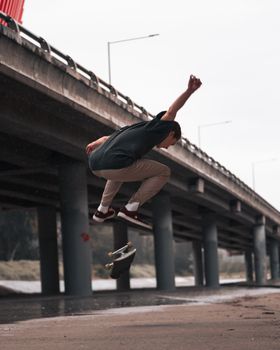 Skateboarder performs a trick under a bridge in Melbourne, capturing the thrill of urban skateboarding.. pexels, skateboarder