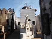 A Statue of Jesus Christ Carrying a Cross in a Cemetery