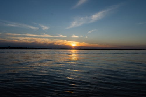  Calm Sea Water Under the Blue Sky During Sunset