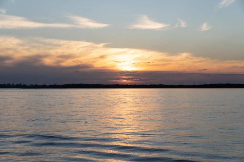 Free Tranquil sunset scene with a calm sea capturing the beauty of nature's colors. Stock Photo