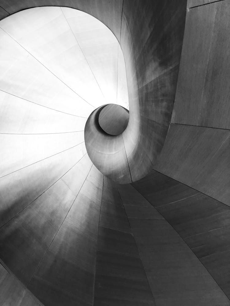 A Gray Spiral Tunnel Made Of Concrete Slabs