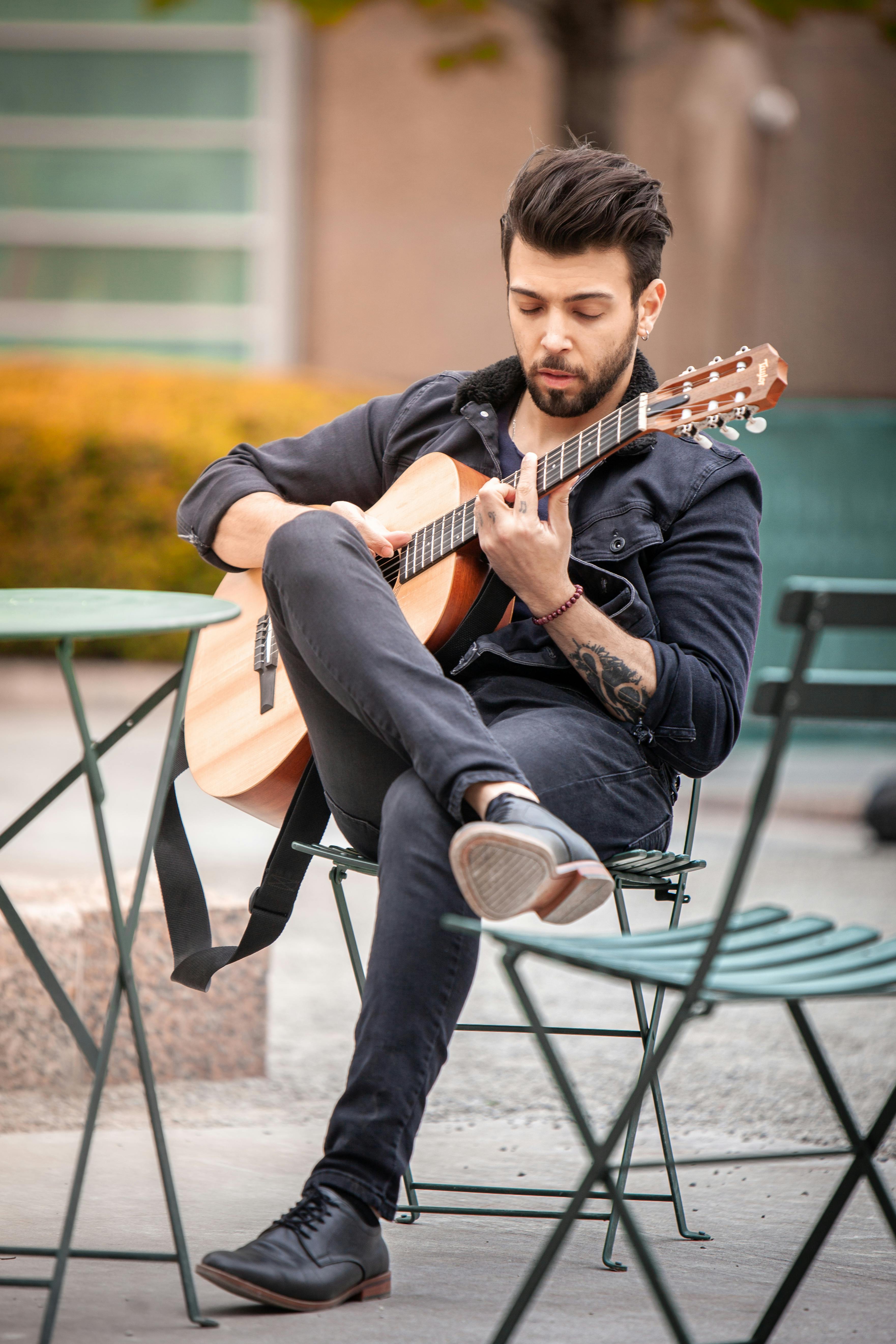 Person Holding Guitar Pick in Close Up Photography · Free Stock Photo