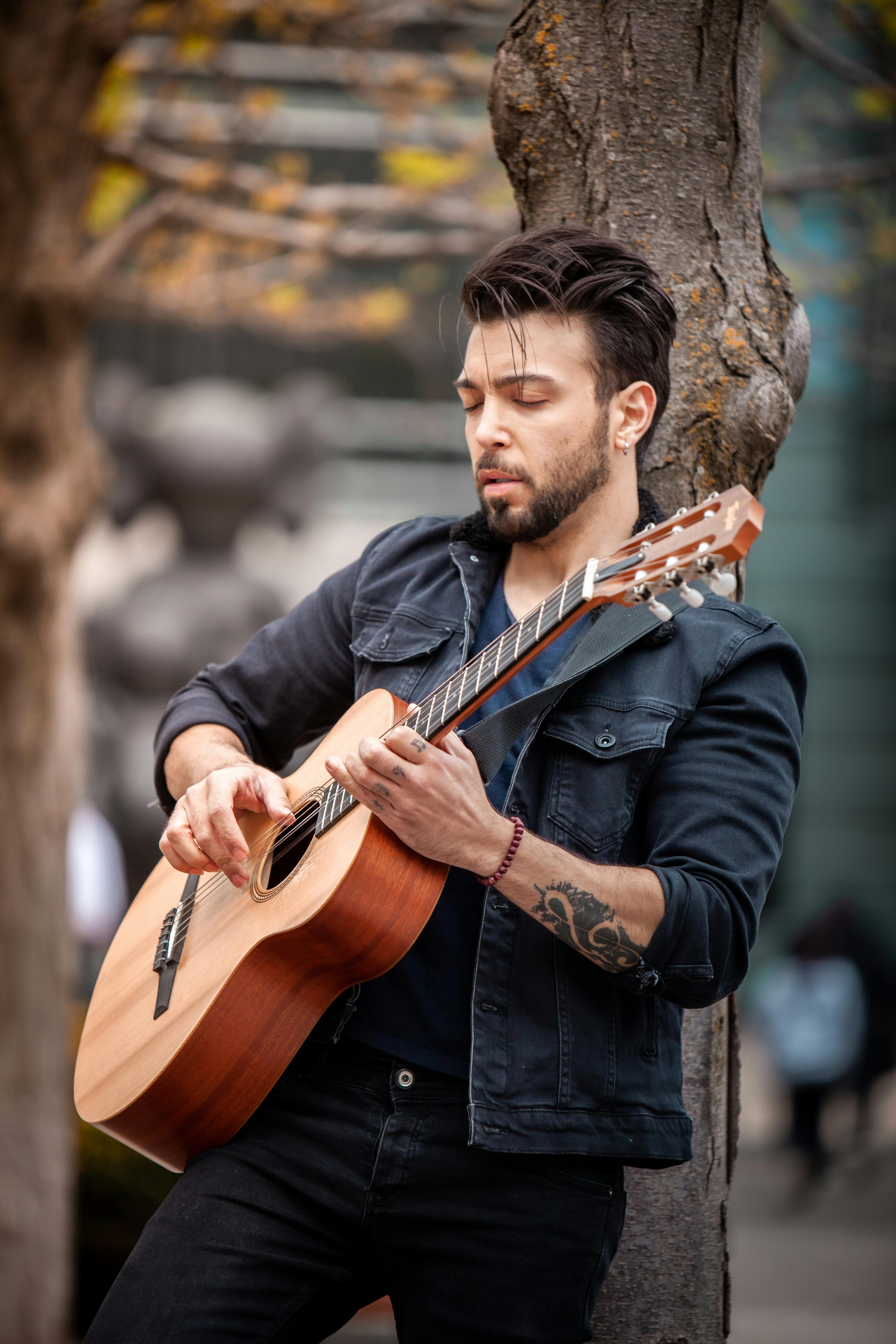 Person Holding Guitar Pick in Close Up Photography · Free Stock Photo