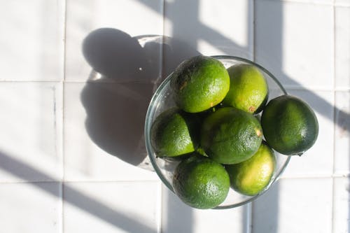 Green Limes on Clear Glass Bowl