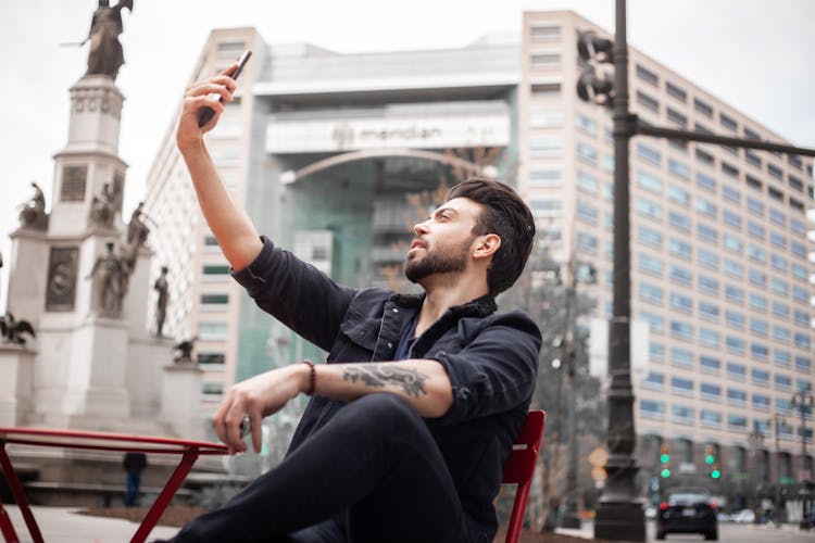 A Bearded Man Taking A Selfie