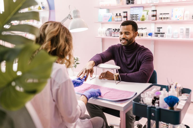 Male client receiving a professional manicure in a modern salon