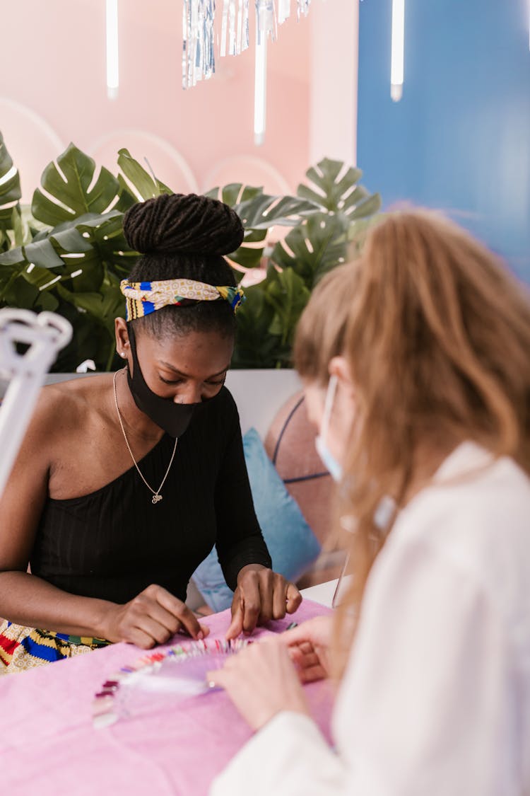 A Woman Choosing Nail Polish Color 