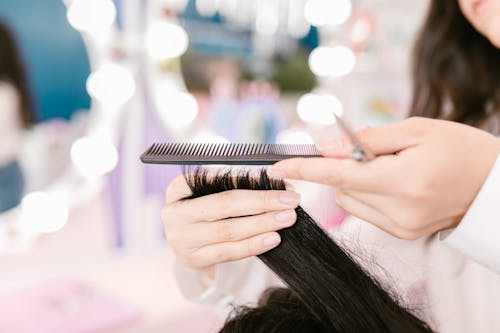 Free Hands Holding Hair and Comb Stock Photo