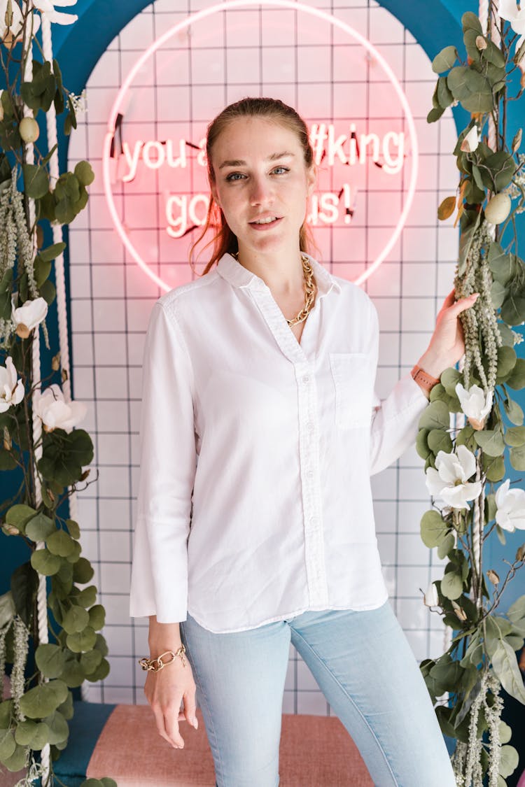 Woman In White Button Up Shirt Standing Beside Green Plant