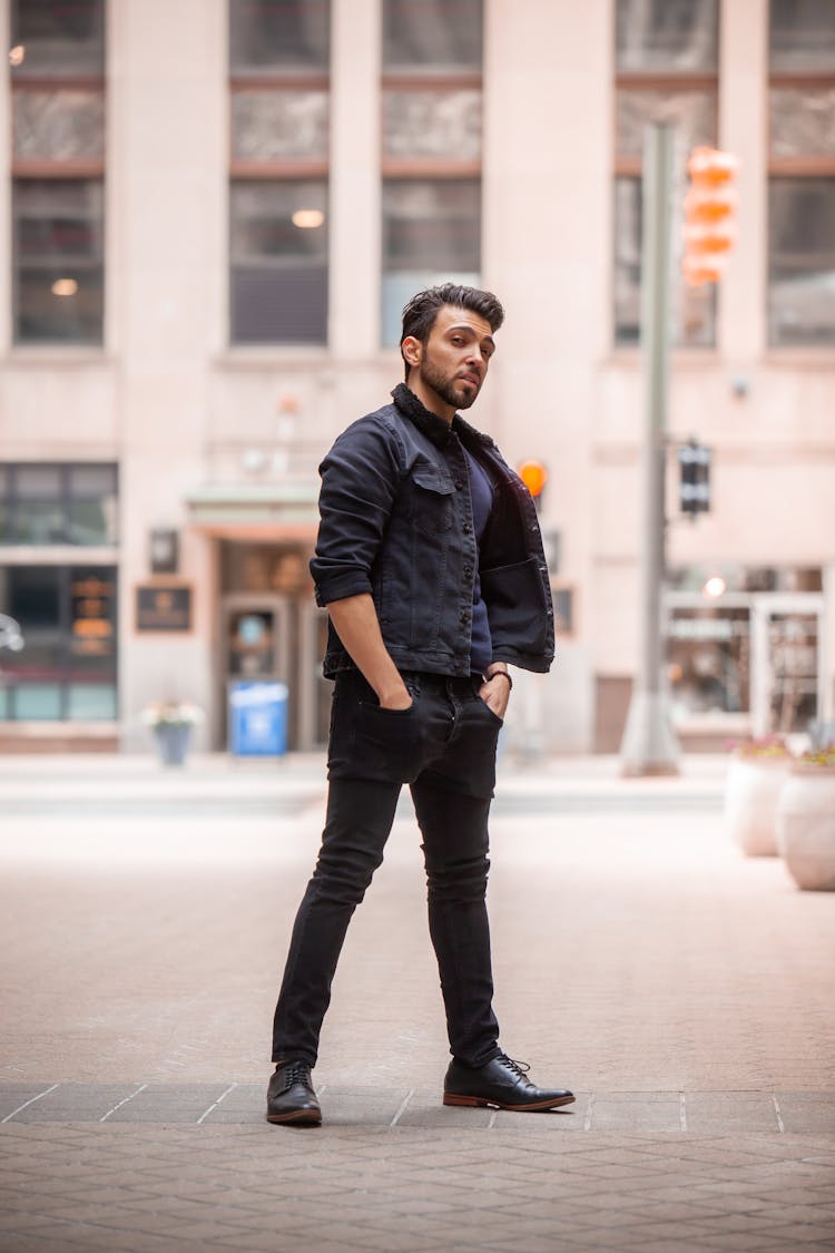 Man In Black Jacket And Black Jeans Standing On Pavement