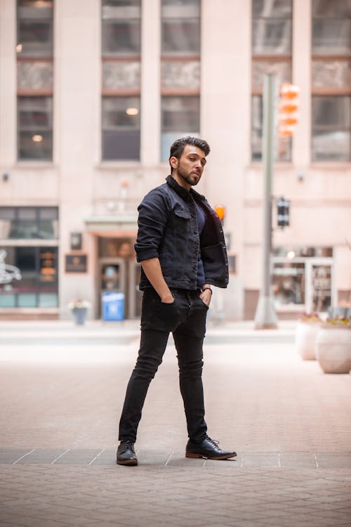 Free Man in Black Jacket and Black Jeans Standing on Pavement Stock Photo
